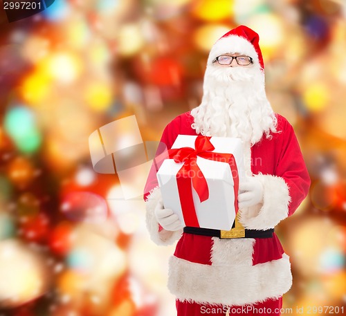 Image of man in costume of santa claus with gift box