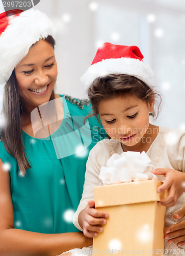 Image of happy mother and child girl with gift box