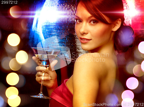 Image of woman with cocktail and disco ball