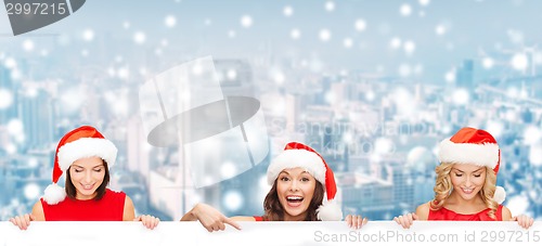 Image of women in santa helper hat with blank white board