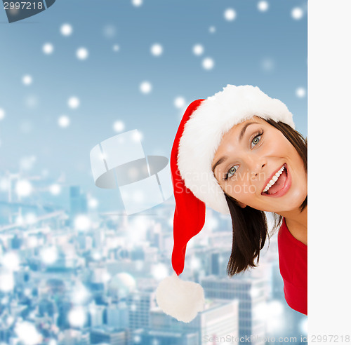 Image of woman in santa helper hat with blank white board