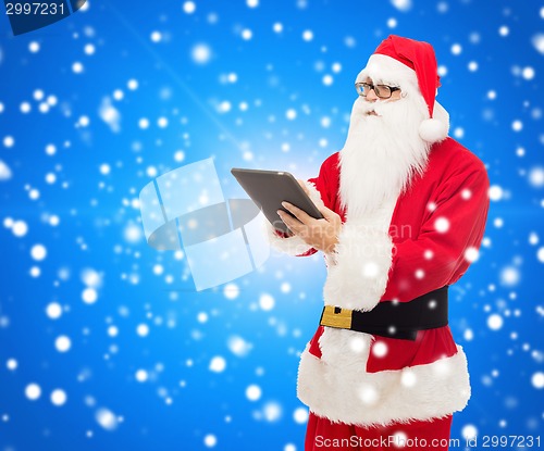 Image of man in costume of santa claus with tablet pc