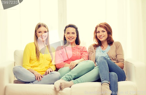 Image of three girlfriends having a talk at home