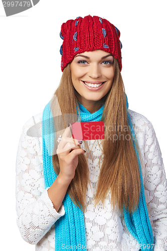 Image of Female in winter hat and scarf showing blank credit card