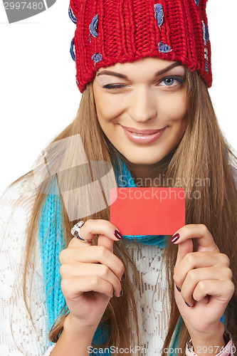 Image of Female in winter hat and scarf showing blank credit card