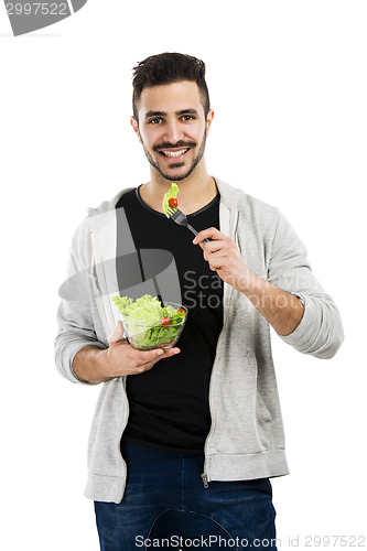 Image of Young man eating a salad
