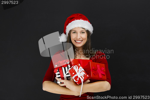 Image of Woman holding christmas gifts