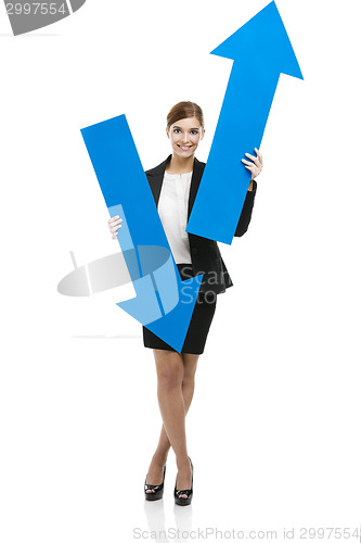 Image of Business woman holding blue arrows