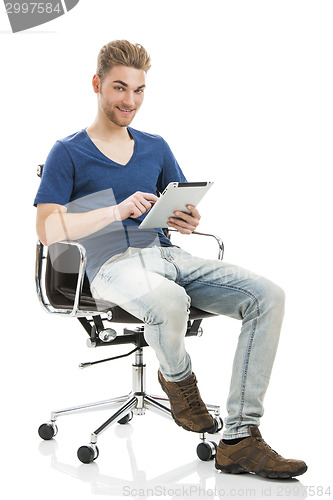 Image of Young man working with a tablet