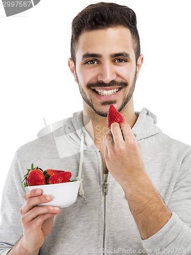 Image of Happy young eating a strawberry
