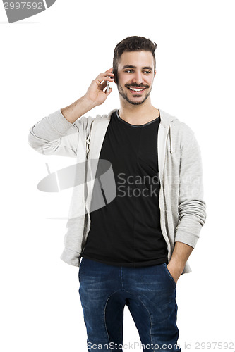 Image of Young man talking on cell phone