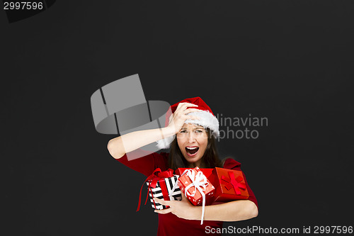 Image of Beautiful woman holding christmas gifts