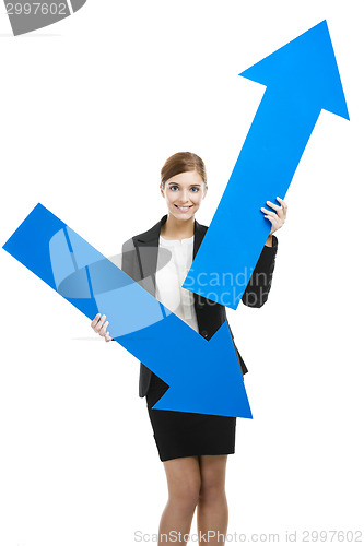 Image of Business woman holding blue arrows