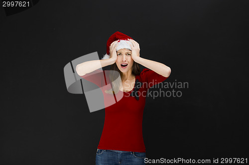 Image of Beautiful woman wearing a santa hat