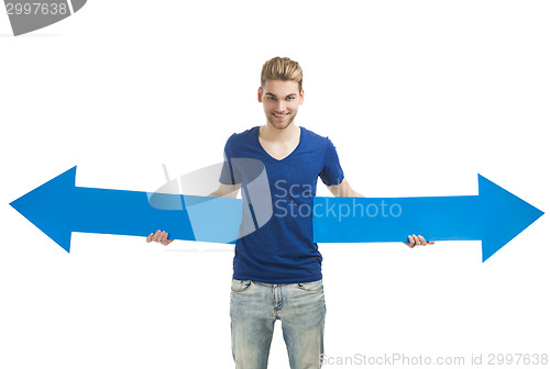 Image of Young man holding a blue arrow