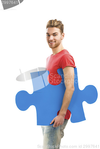 Image of Young man holding a puzzle piece