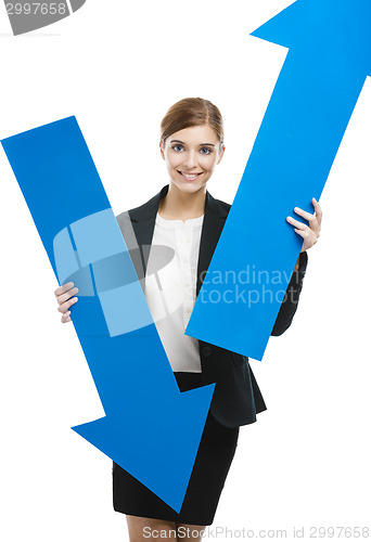 Image of Business woman holding blue arrows