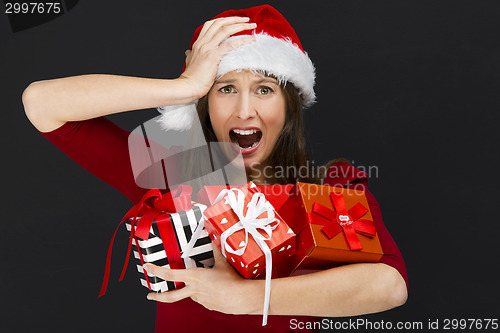 Image of Woman holding christmas gifts