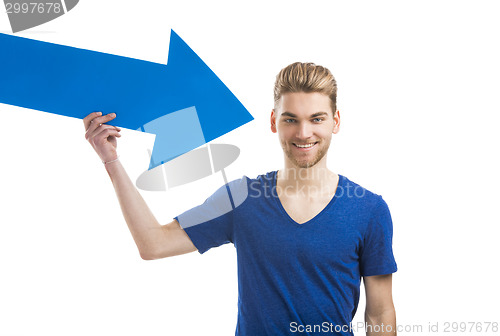 Image of Young man holding a blue arrow