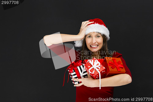 Image of Woman holding christmas gifts