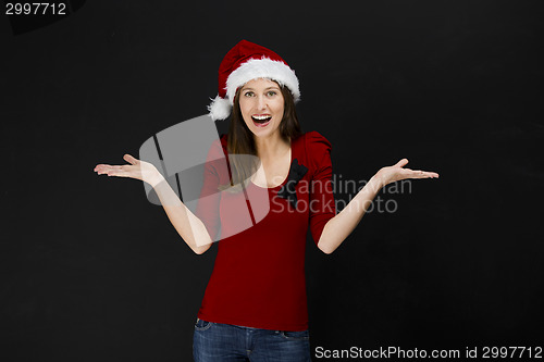 Image of Beautiful woman wearing a santa hat