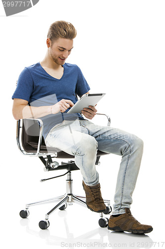 Image of Young man working with a tablet