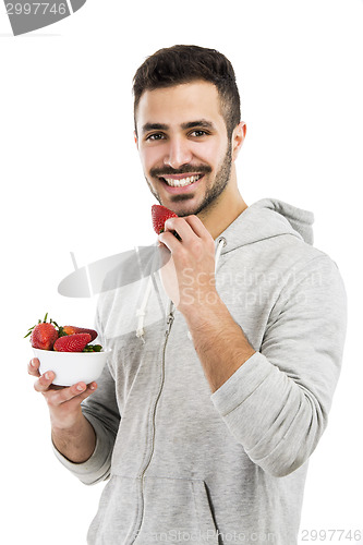 Image of Happy young eating a strawberry