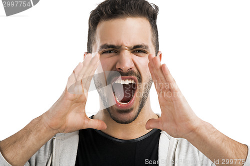 Image of Portrait of a latin american young man shooting out loud