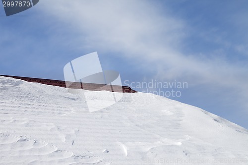 Image of Roof in snow and blue sky