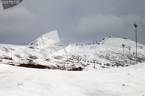 Image of Ski slopes at gray day, in little snow year