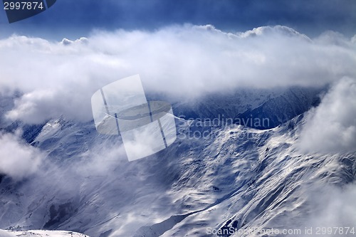 Image of View on snowy mountains at mist