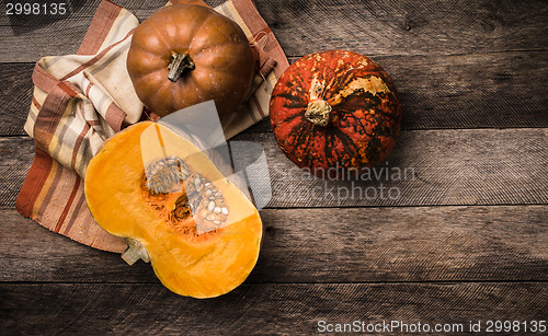 Image of Rustic style pumpkins  with napkin and wood 