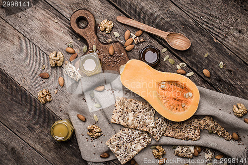 Image of Pumpkin nuts and cookies with seeds on wooden table