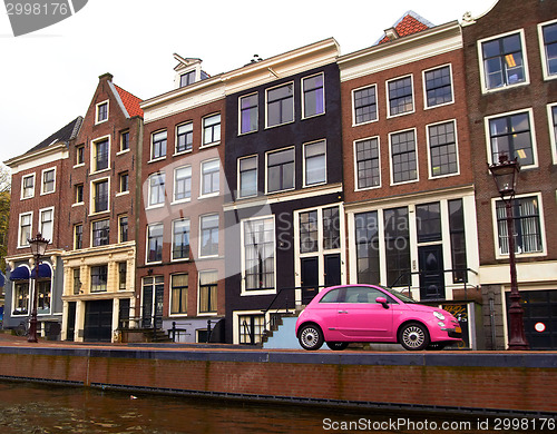 Image of pink car on a canal in Amsterdam, Netherlands