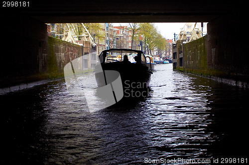 Image of boat going under the bridge