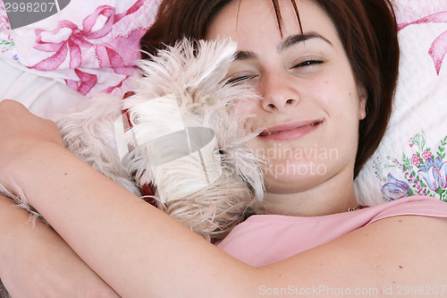 Image of Dog sleeping on bed 
