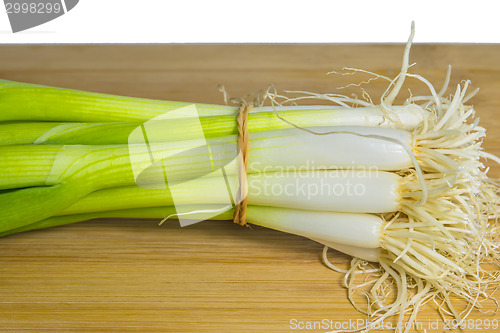 Image of spring onion on a plank