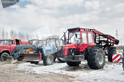 Image of Tractors and truck stand on open area