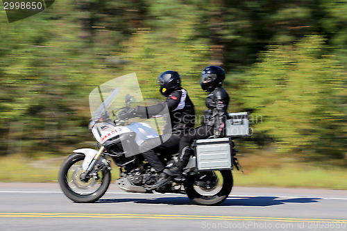 Image of Two Bikers Riding a Motorcycle, motion blur