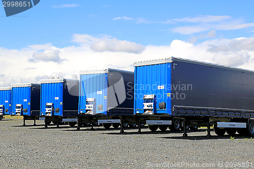 Image of Row of Blue Trailers on a Yard