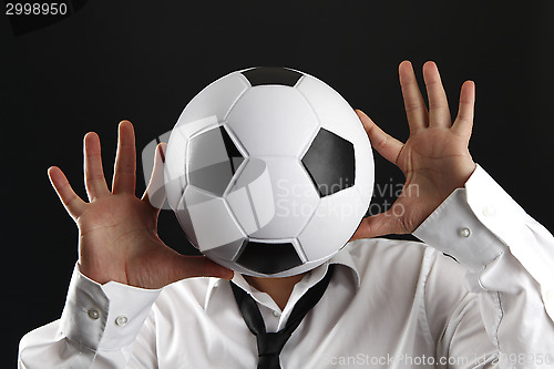 Image of Attractive man with white shirt and football