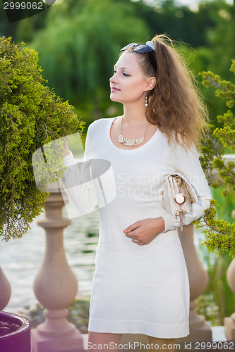 Image of Attractive woman wearing white dress