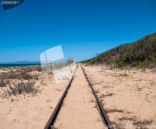 Image of Steel Railroad Tracks on Sand Beach