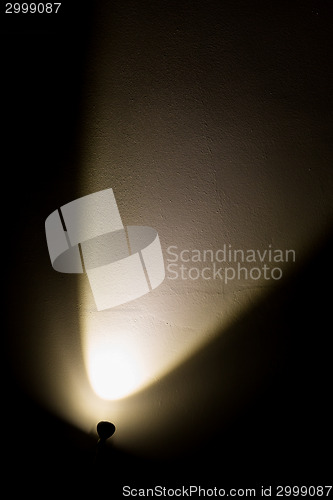 Image of Dark Wall Illuminated from the Left Corner Spotlight Lamp