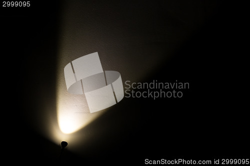 Image of Dark Wall Illuminated from the Left Corner Spotlight Lamp