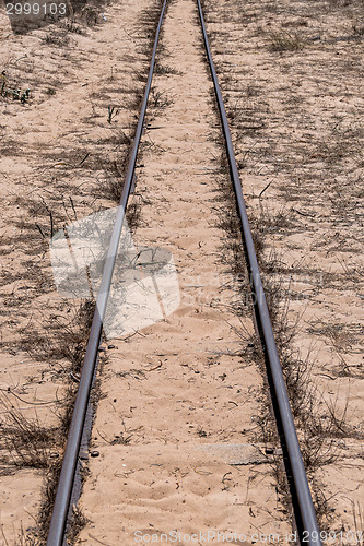 Image of Steel Railroad Tracks on Sand Beach