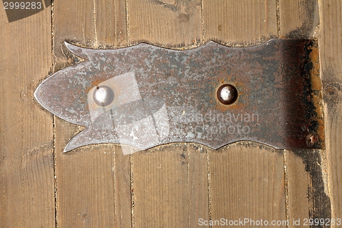 Image of old metallic door hinge