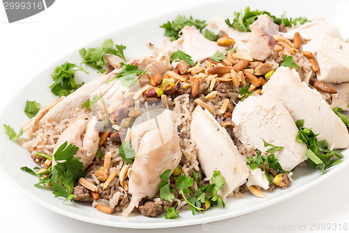 Image of Lebanese chicken and spiced rice with nuts and parsley