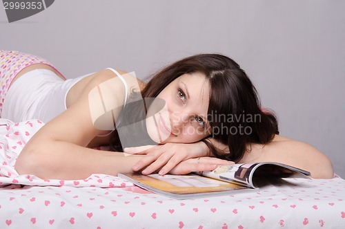 Image of Beautiful girl reading a magazine dreams