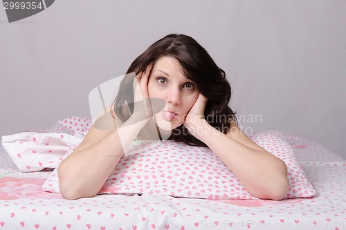 Image of girl woke up in the morning shows tongue